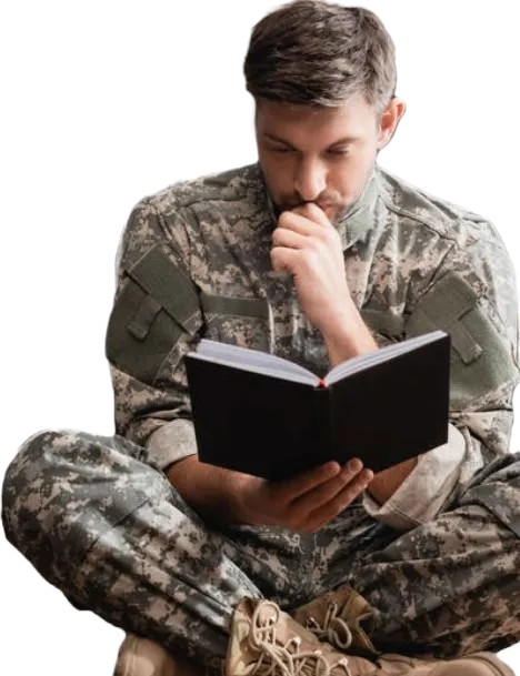 Picture of a veteran sitting and reading a book.