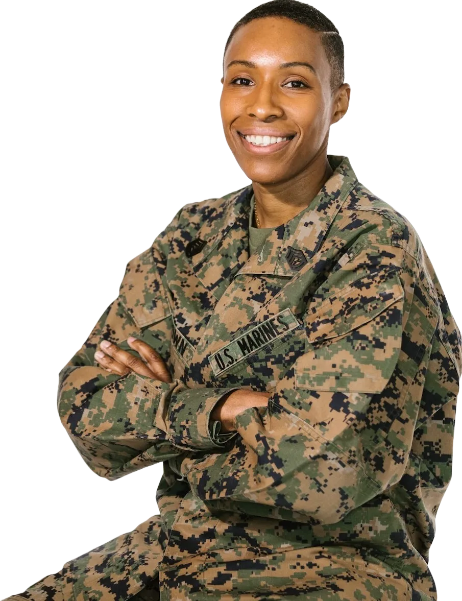 Picture of a veteran sitting with arms crossed smiling